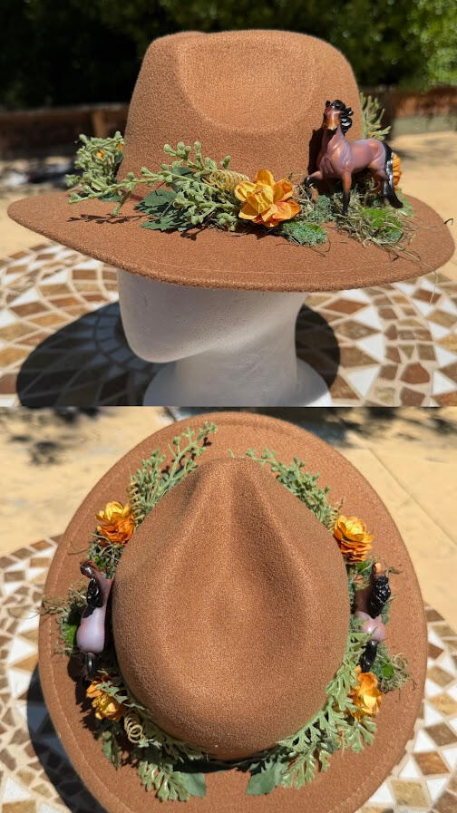 Warm brown short brim hat with Breyer stablemates. Decorated with faux greenery and golden flowers.