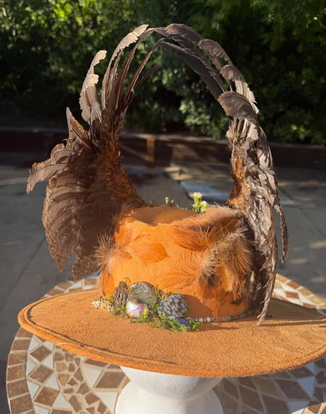 More bright natural stones cluster at the back of the hat for a pop of color. Strand of multicolor natural bead stones line the rim of the hat.